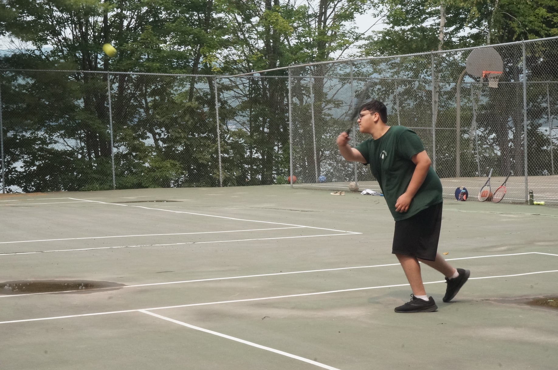 Kid playing tennis at camp